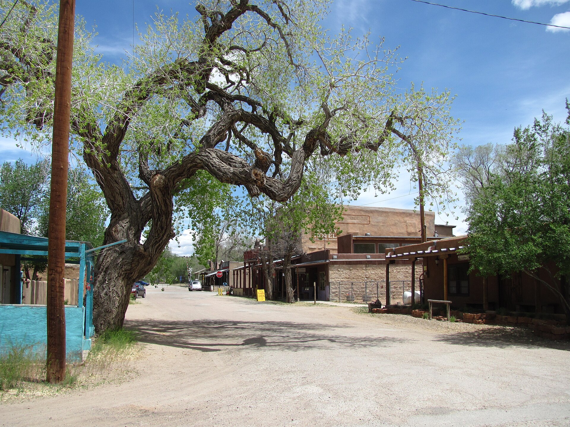 First Street in Cerrillos, New Mexico, with adobe storefronts along a dirt street