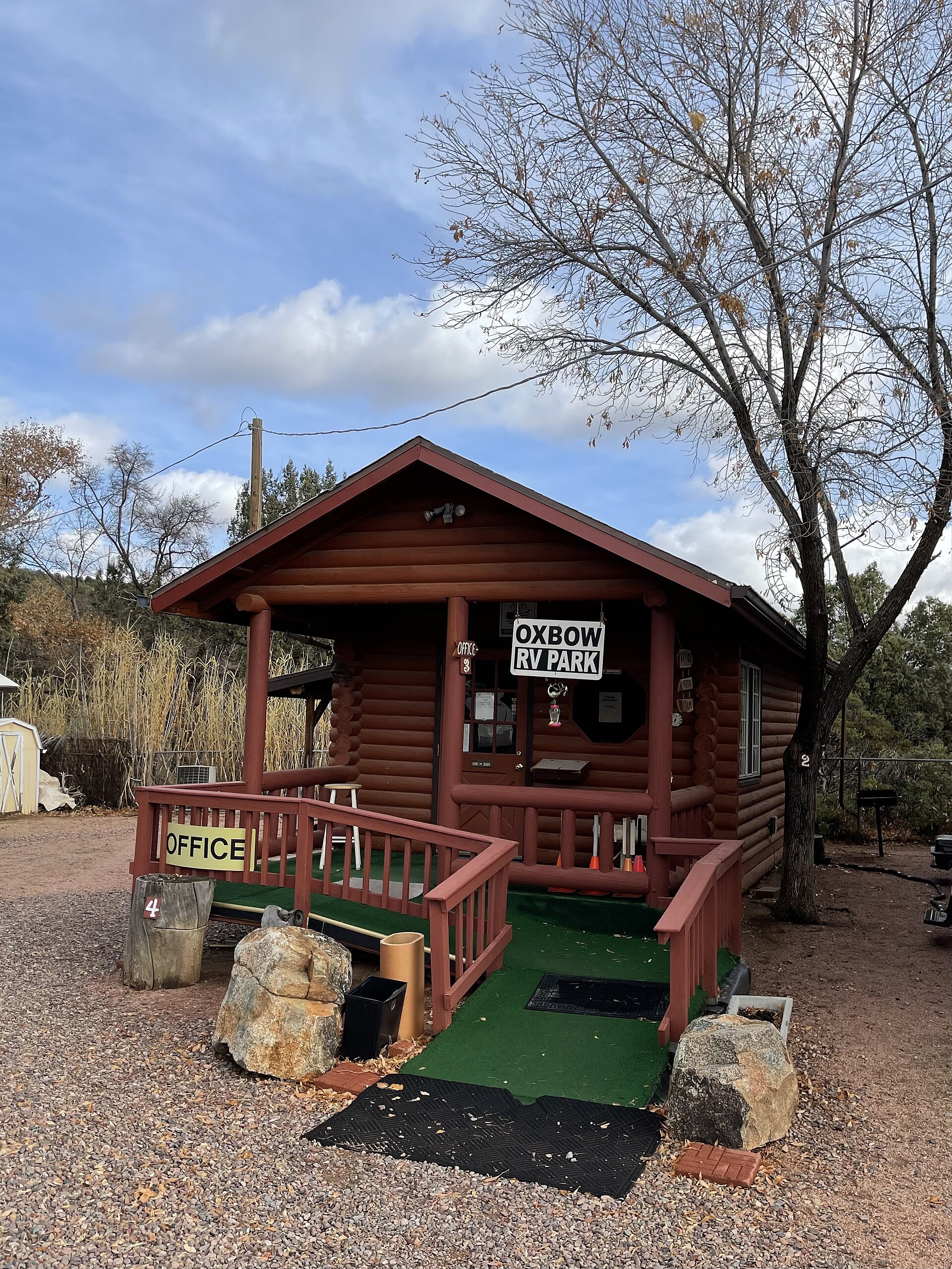 A small wood-sided cabin serving as the RV park office at Oxbow Estates, Arizona.