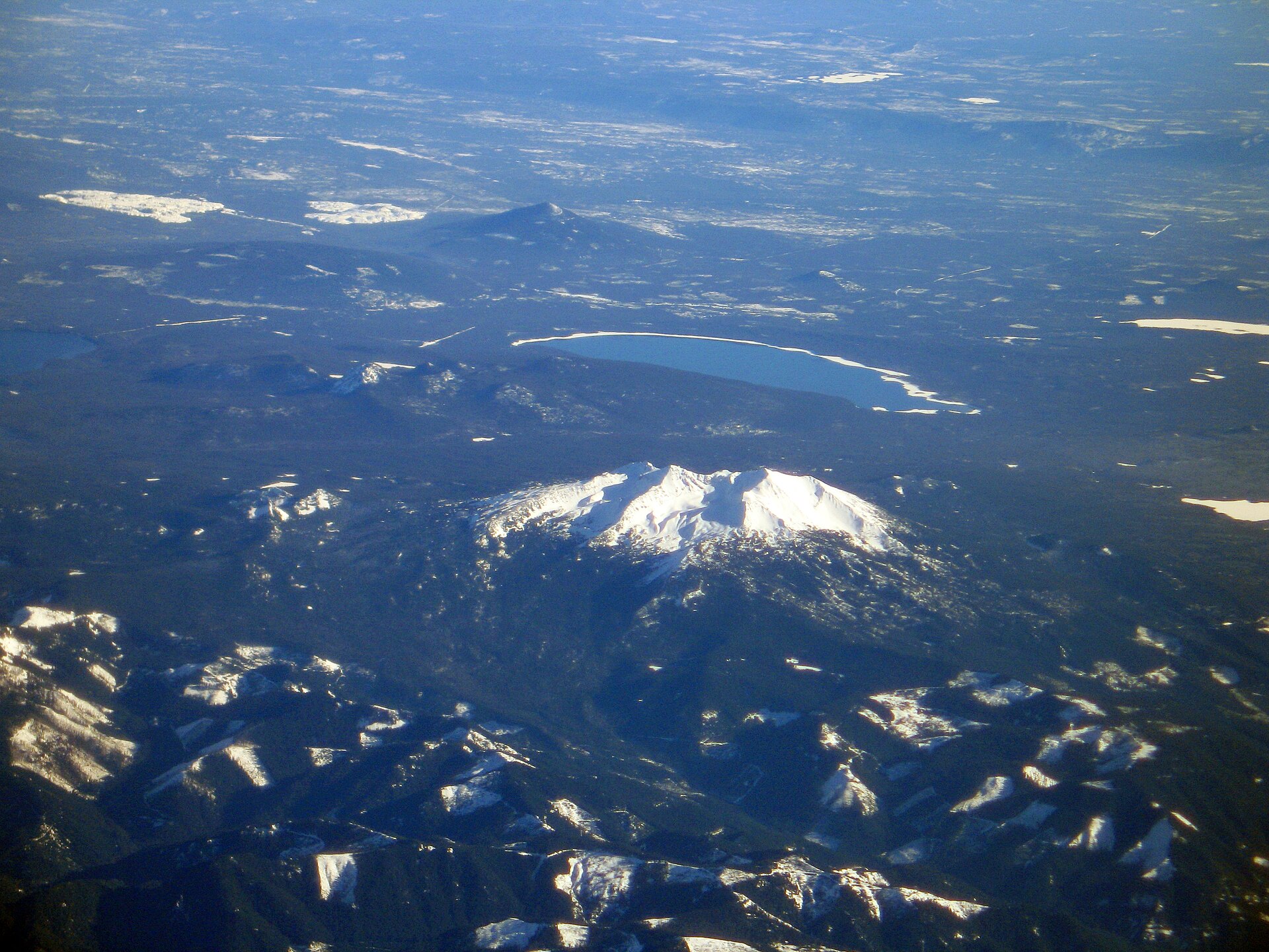 Aerial view of Diamond Peak rising behind Crescent Lake, Oregon.