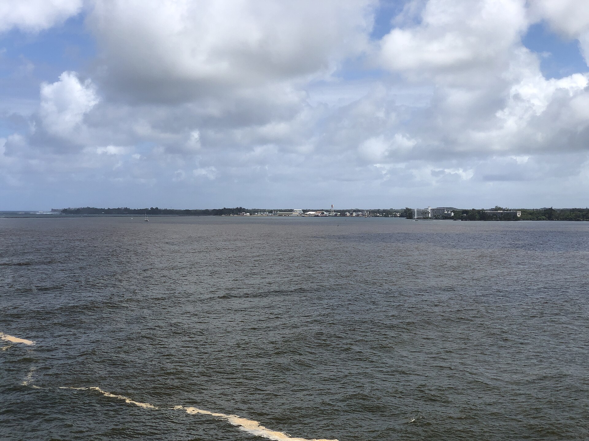 Wide view across Hilo Bay toward the town of Hilo under cloudy skies