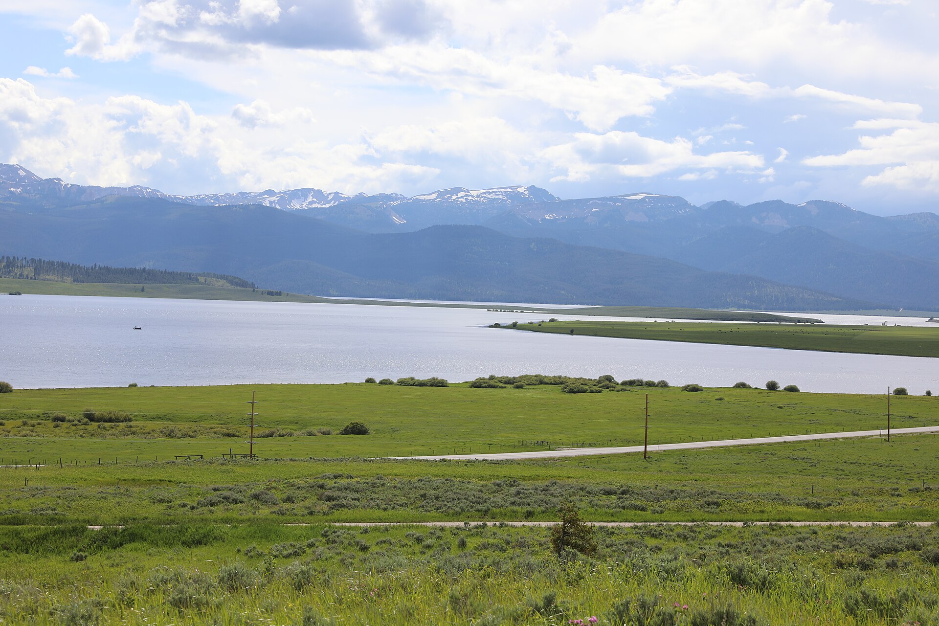 Hebgen Lake with forested shoreline and mountains beyond.