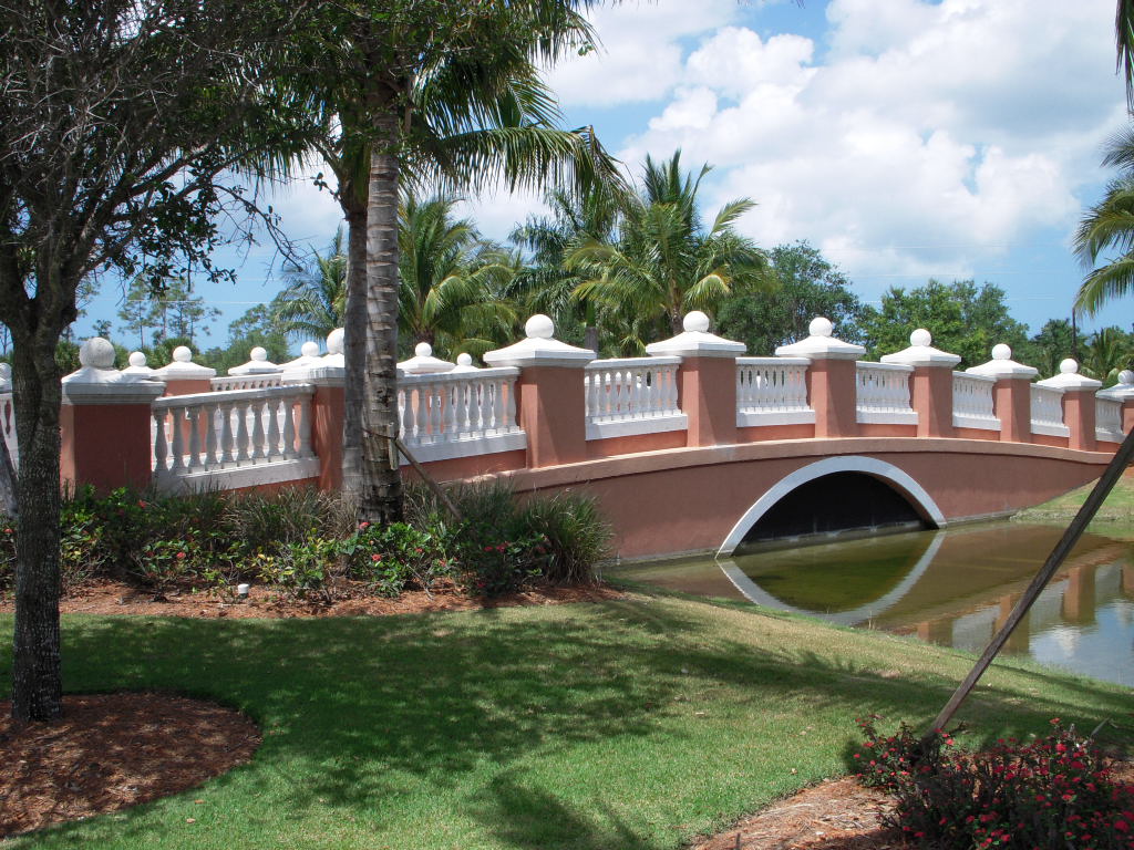 A decorative stucco bridge over a waterway at the entrance of the Verona Walk community in Cape Coral, Florida