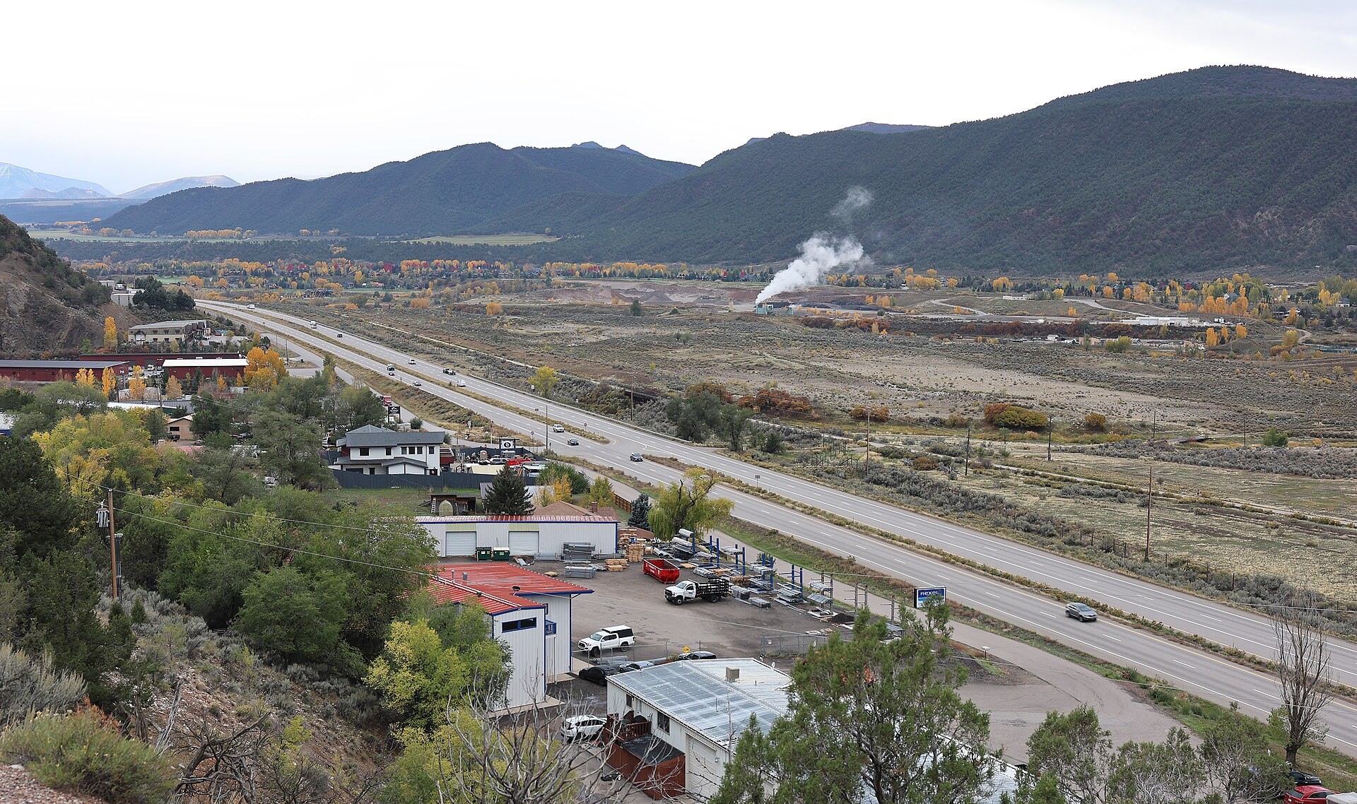 A view of Cattle Creek, Colorado (bottom), a census-designated place in Garfield County, Colorado . The view also includes Colorado State Highway 82 . The valley is the Roaring Fork Valley .