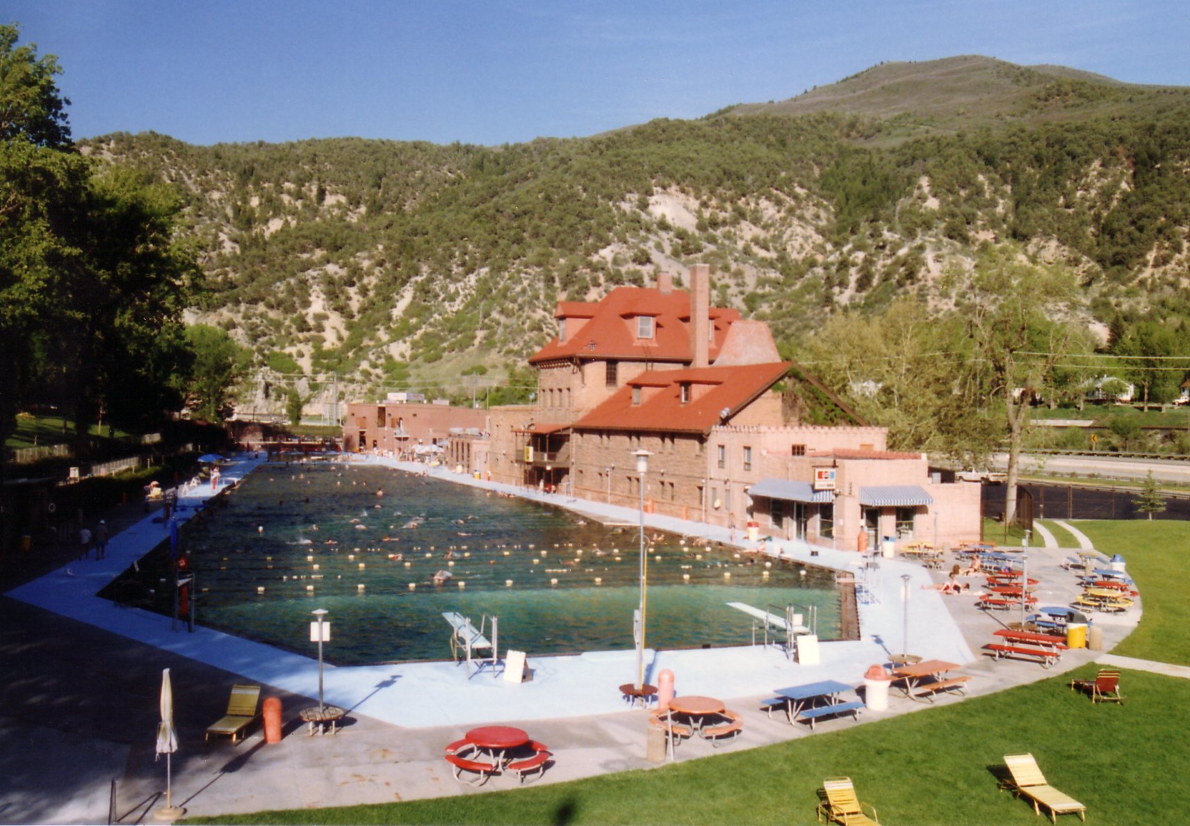 People swimming in the large hot springs pool in Glenwood Springs Colorado.