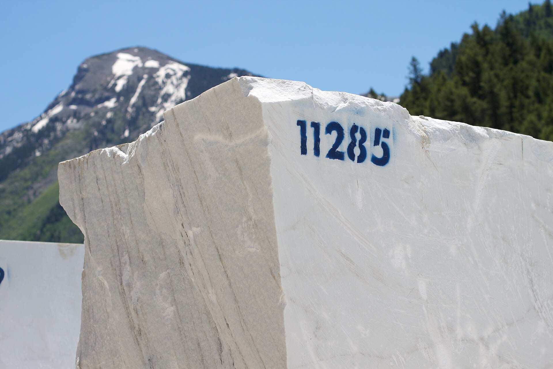 A large block of white marble set against the mountain landscape near Marble, Colorado.