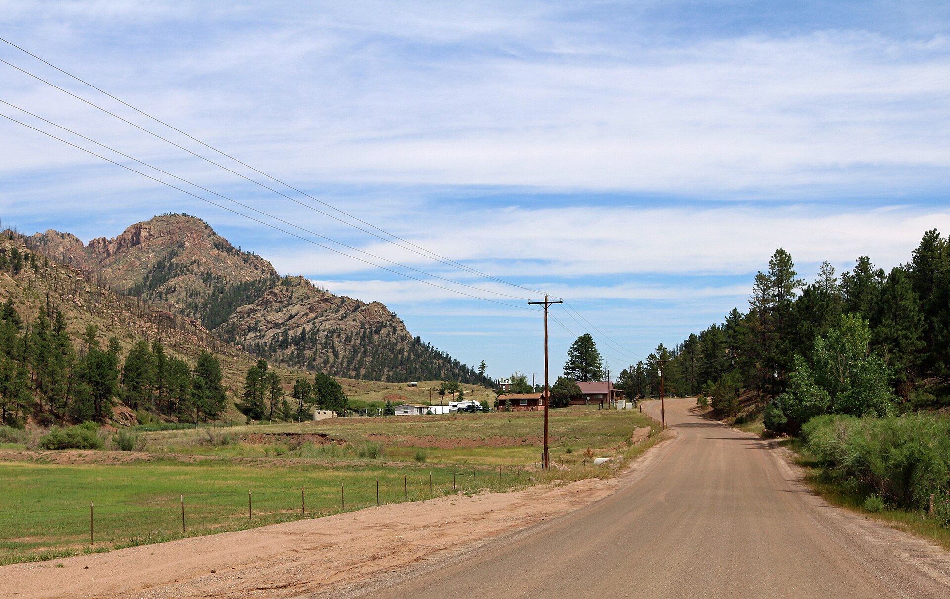 A dirt road in Westcreek, Colorado, running toward forested mountains