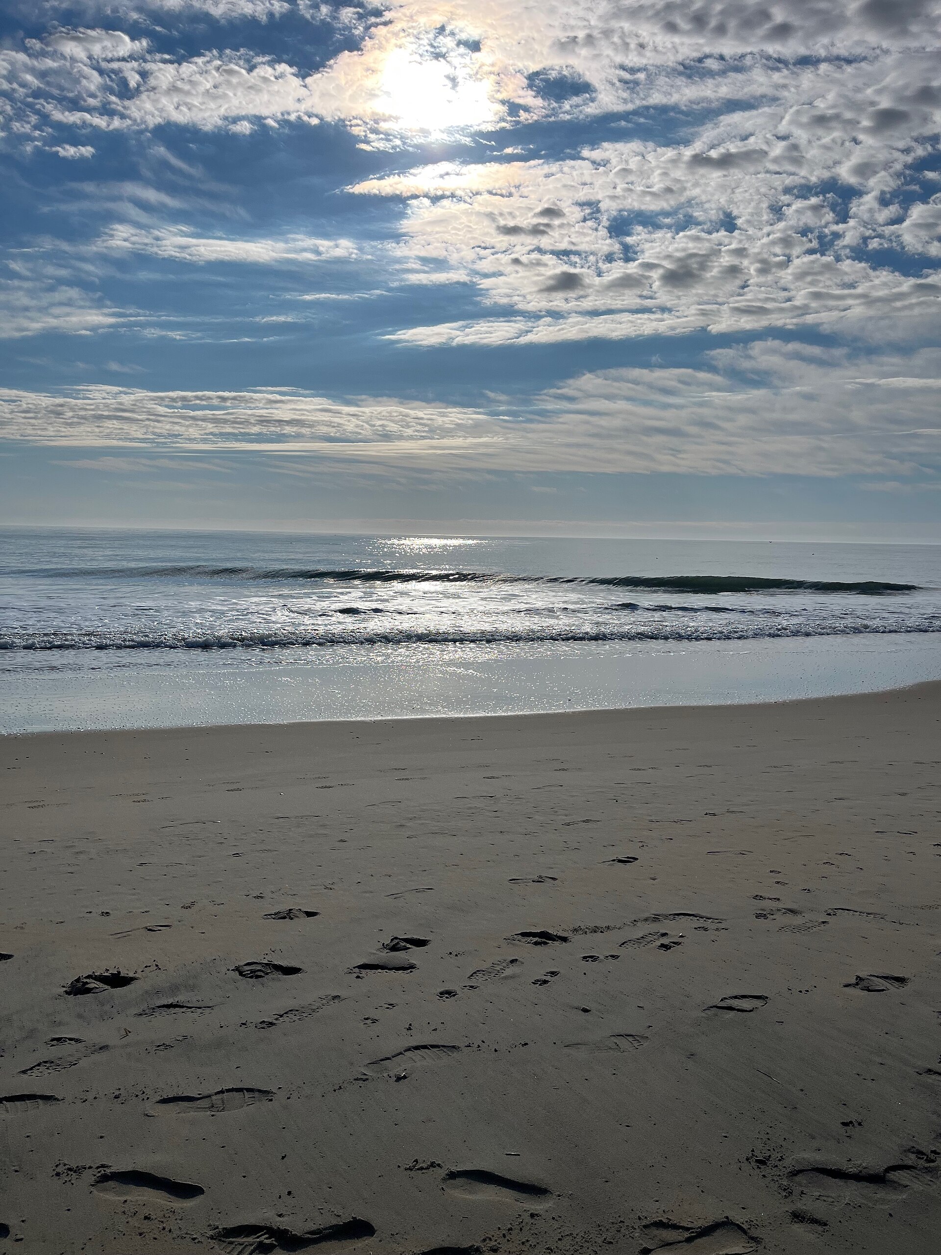 Sandy beach with ocean waves at Bethany Beach Delaware.