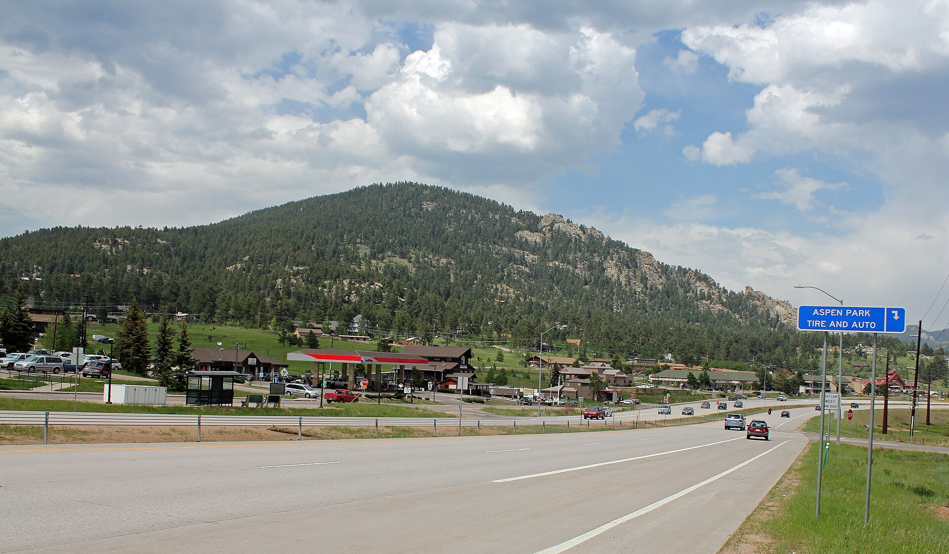 U.S. Highway 285 passing through Aspen Park, Colorado, with forested mountains beyond