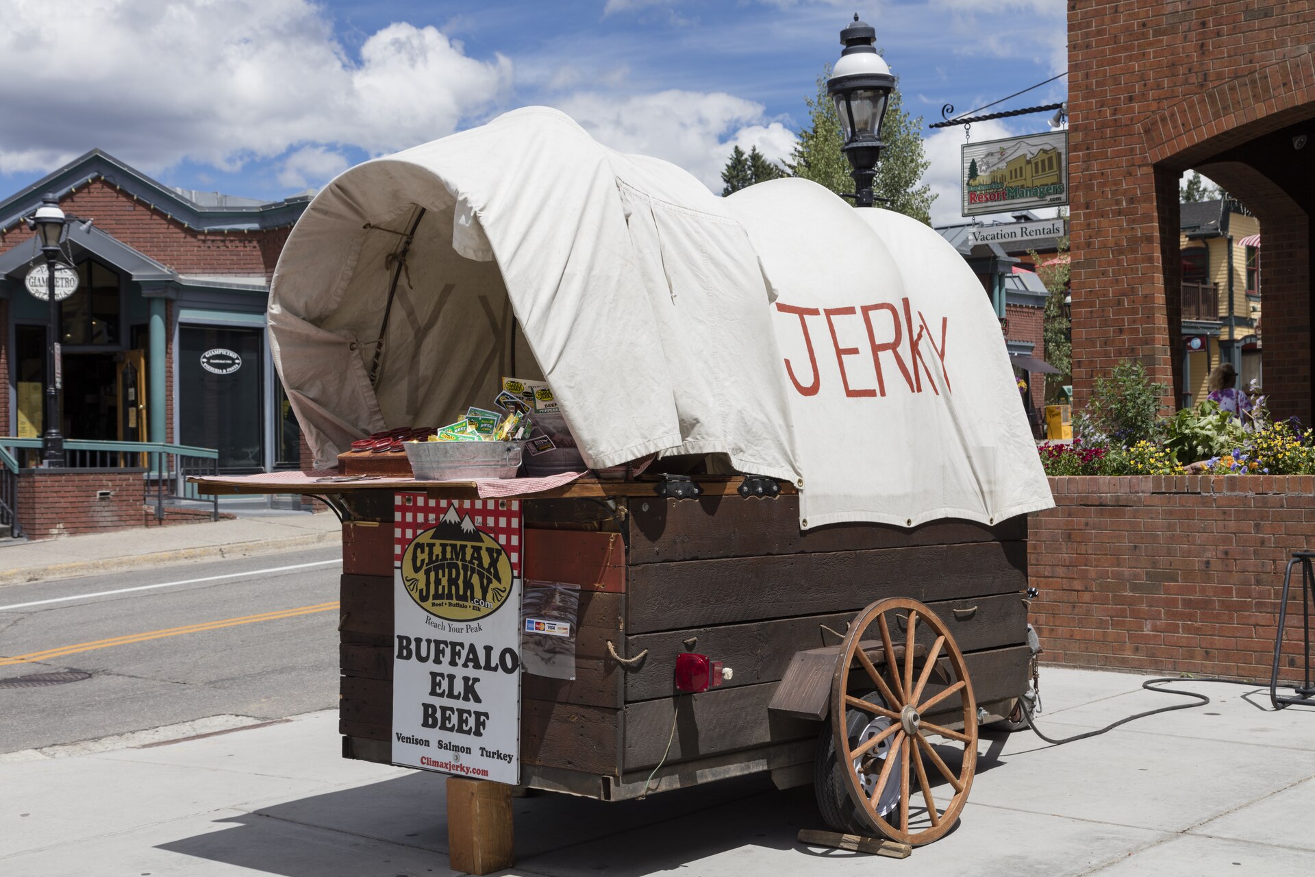 Title: A wagon whose owner sells various kinds of jerky, or lean meat (in this case from cattle, bison, and elk) that has been trimmed of fat, cut into strips, and then dried to prevent spoilage....