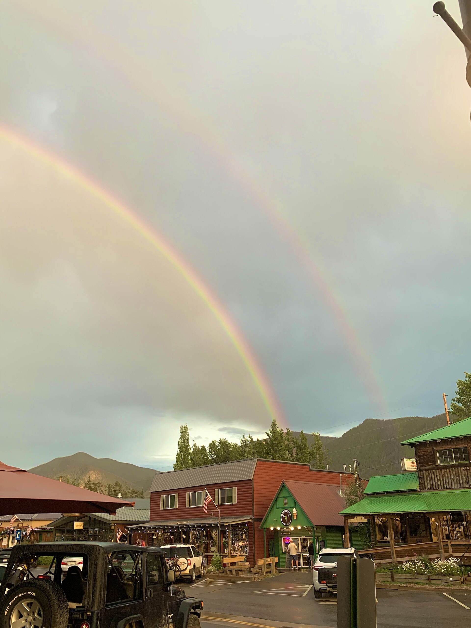 A double rainbow arcing over Grand Lake, Colorado