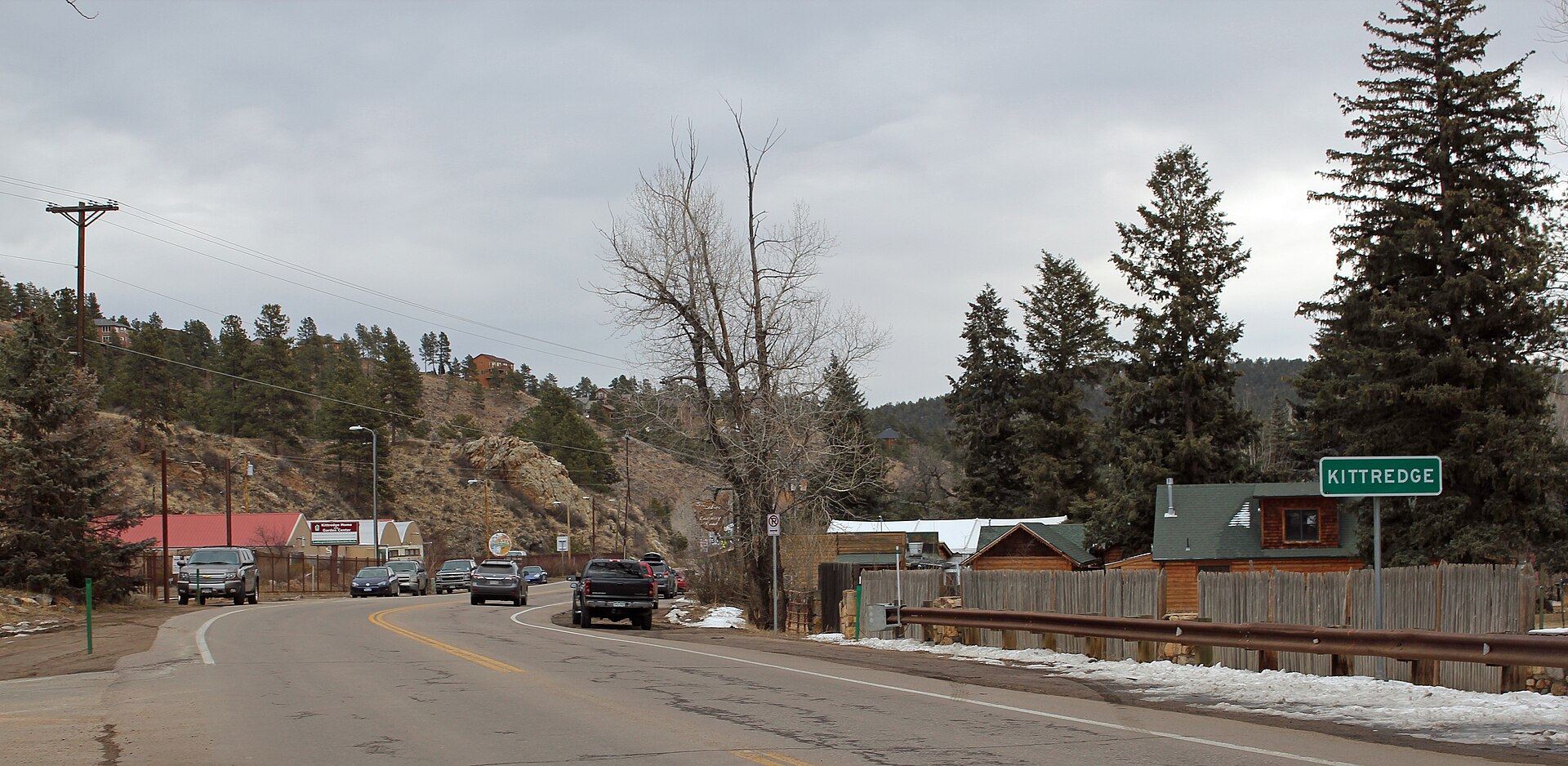 A mountain road through Kittredge, Colorado, with a Kittredge sign
