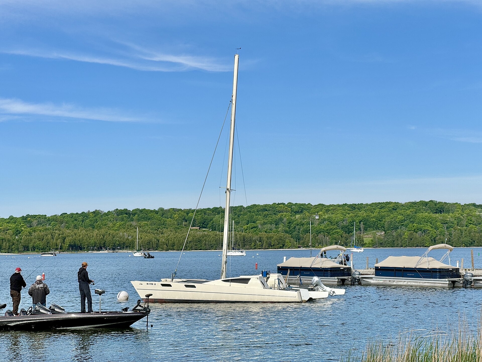 Sailboats anchored in Eagle Harbor with the Ephraim shoreline beyond.