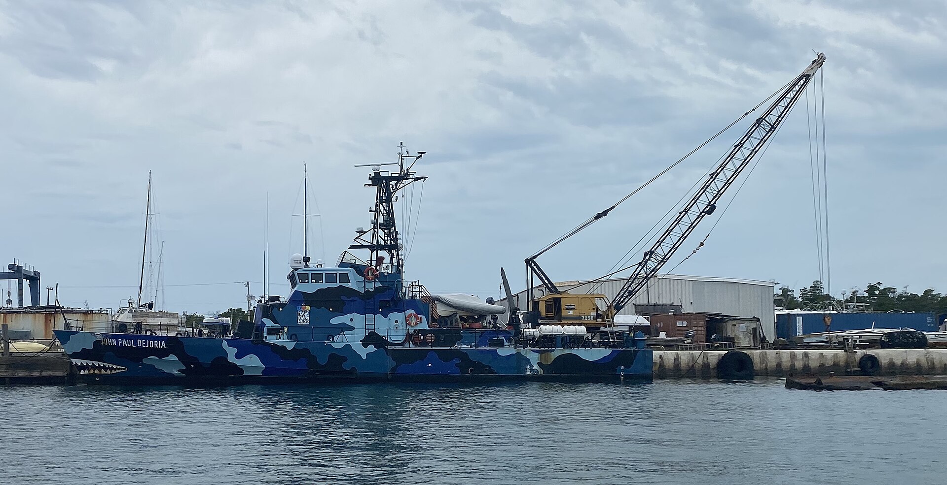A patrol boat docked in the working harbor on Stock Island.