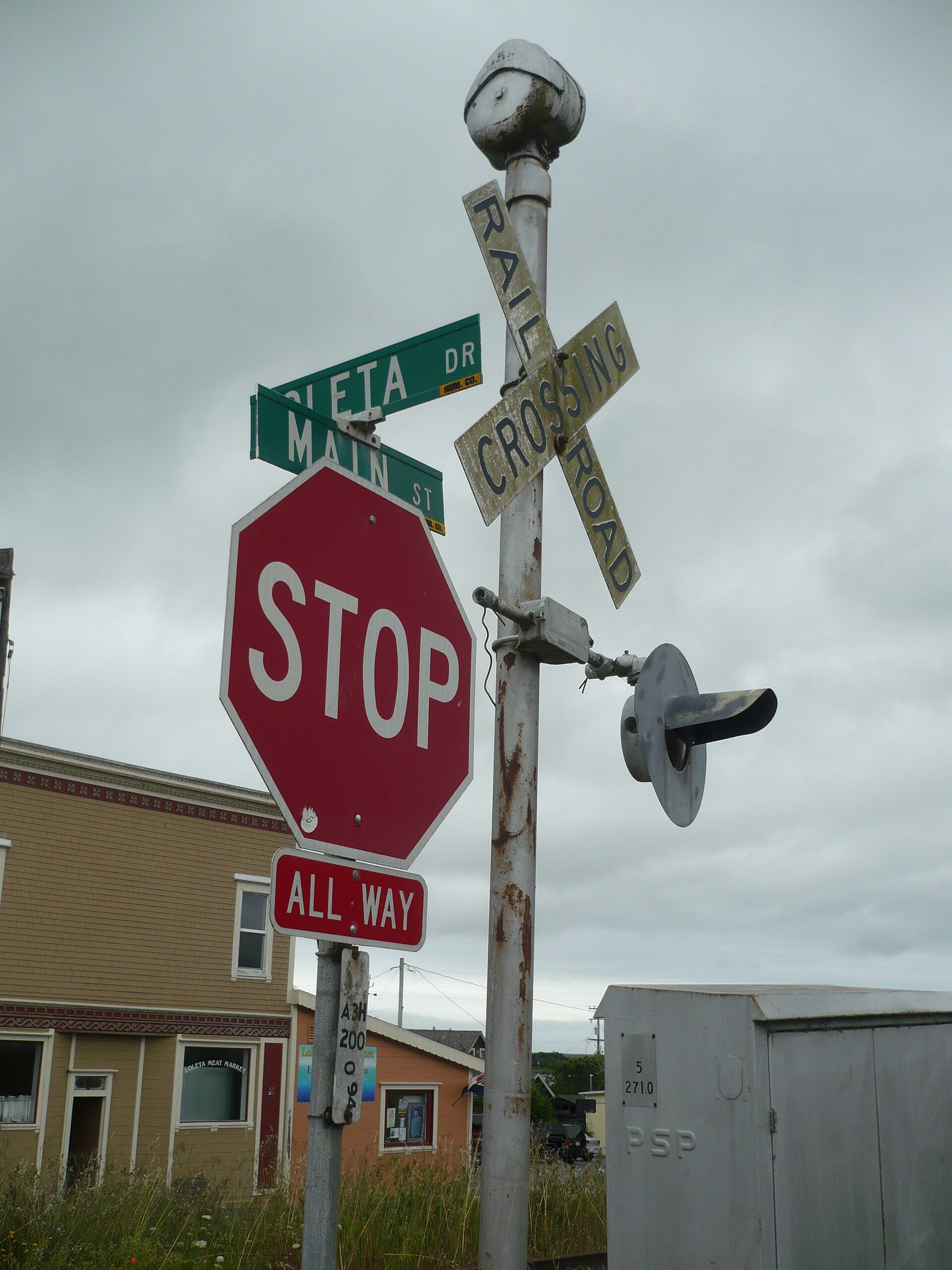 Street signs at the railroad crossing on Main Street in downtown Loleta, California