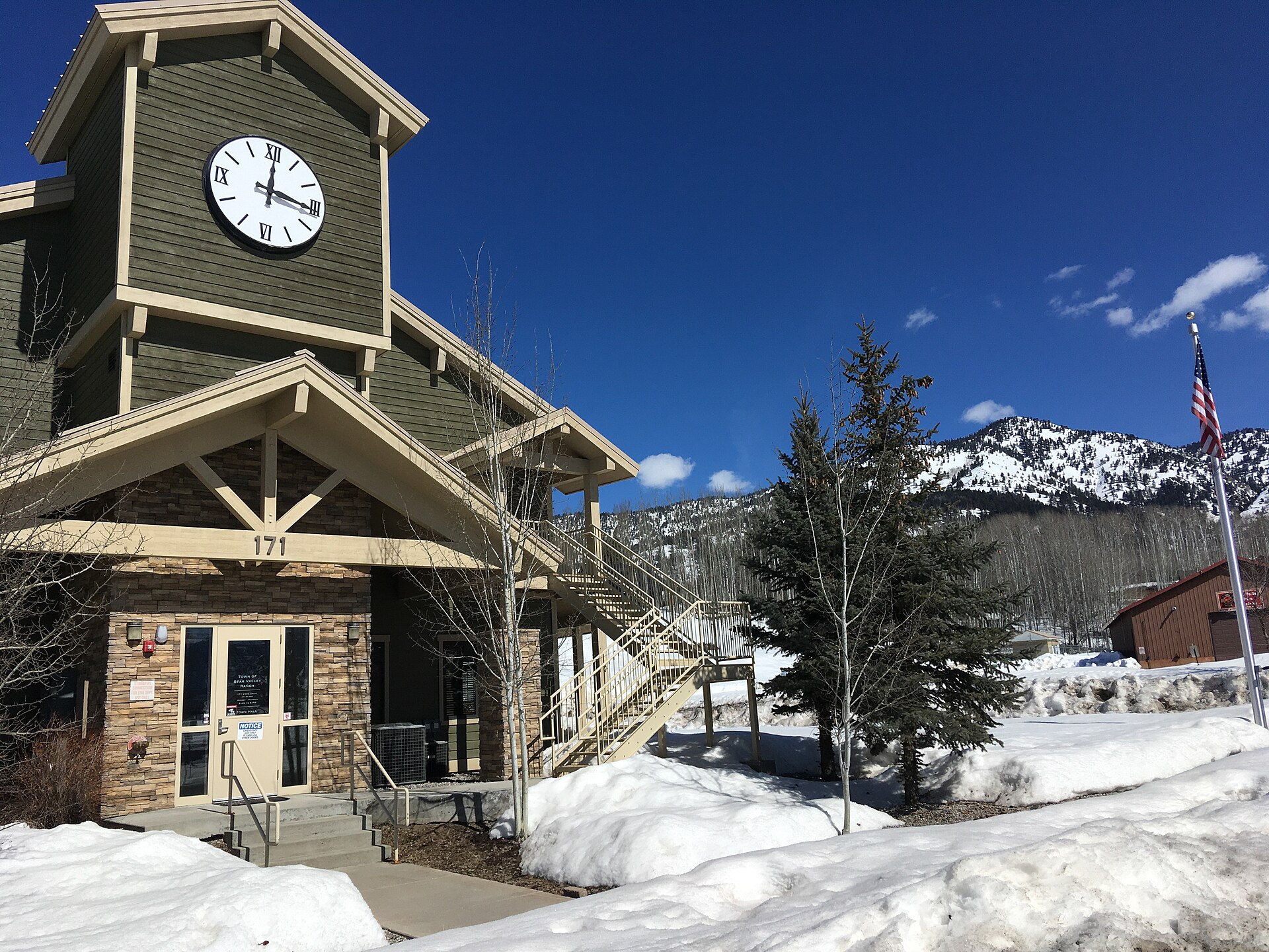 Star Valley Ranch Town Hall with a clock tower, surrounded by snow