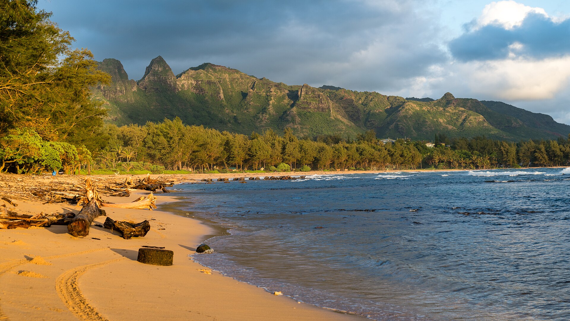 Beach at Anahola Beach Park on Kauai with the Kalalea Mountains rising behind