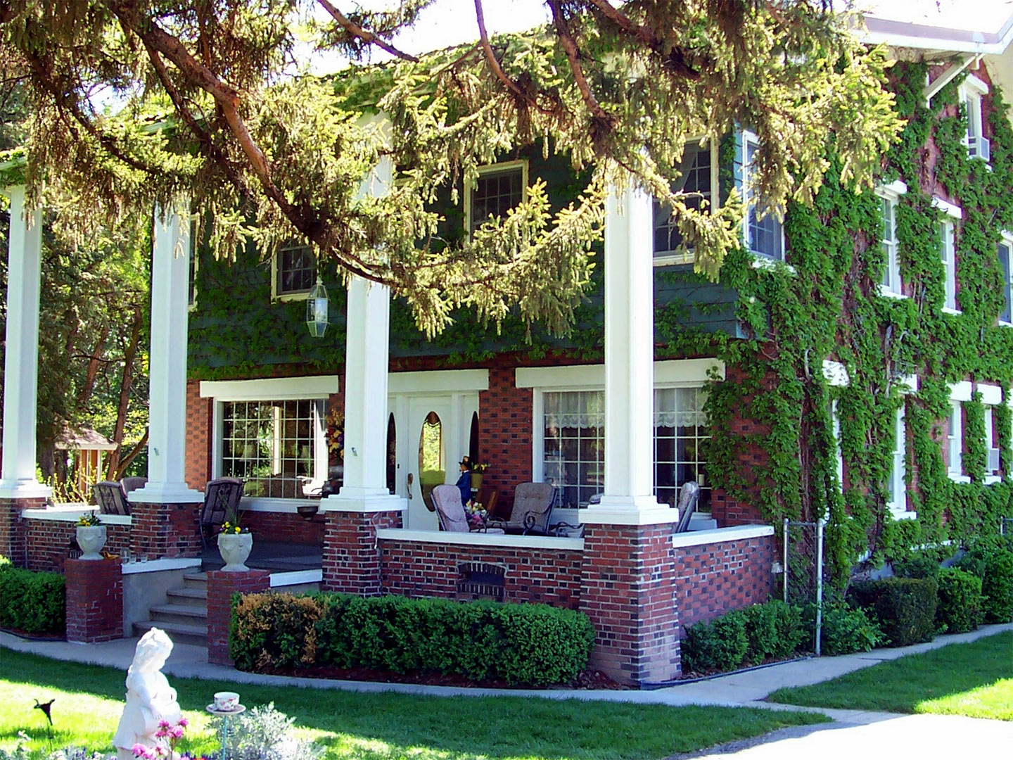 Ivy-covered brick home with white columns in Sunnyslope