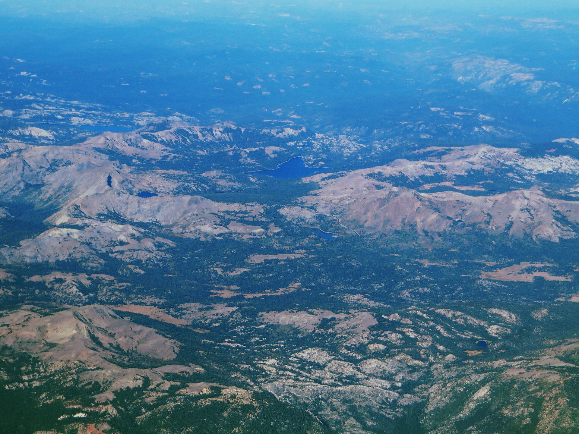 An aerial view of forested mountains and valleys around Kirkwood Mountain Resort, California.