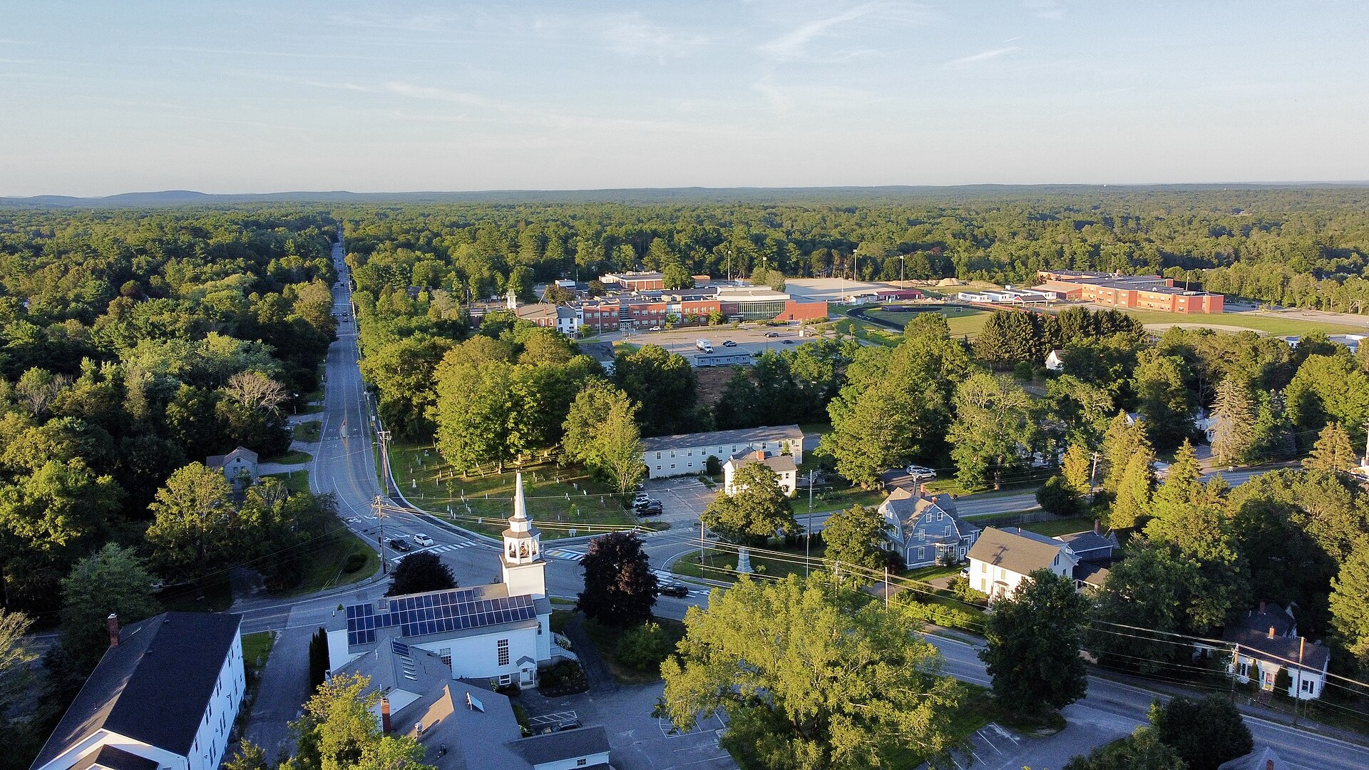 Aerial view over Cumberland Center with a white church steeple