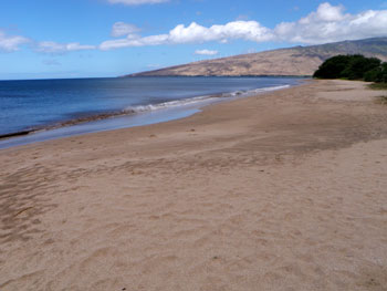 Sandy beach curving along Maalaea Bay with the West Maui Mountains in the distance