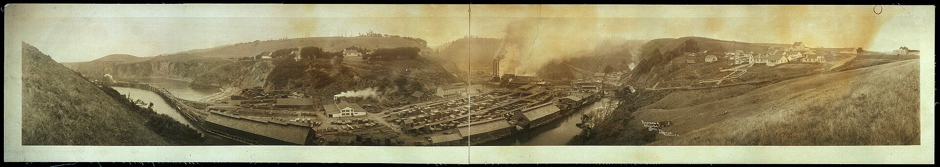 A sepia 1911 panorama photograph of Albion, California, showing the harbor and surrounding hills.