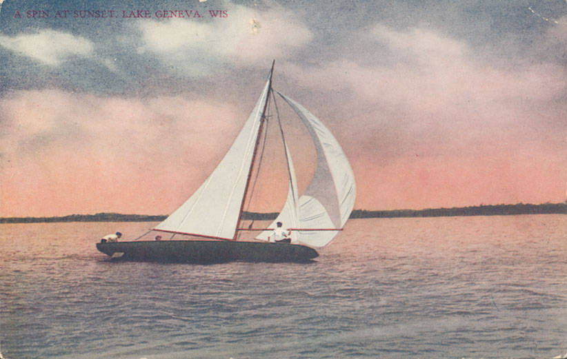 A sailboat gliding across Geneva Lake at sunset.