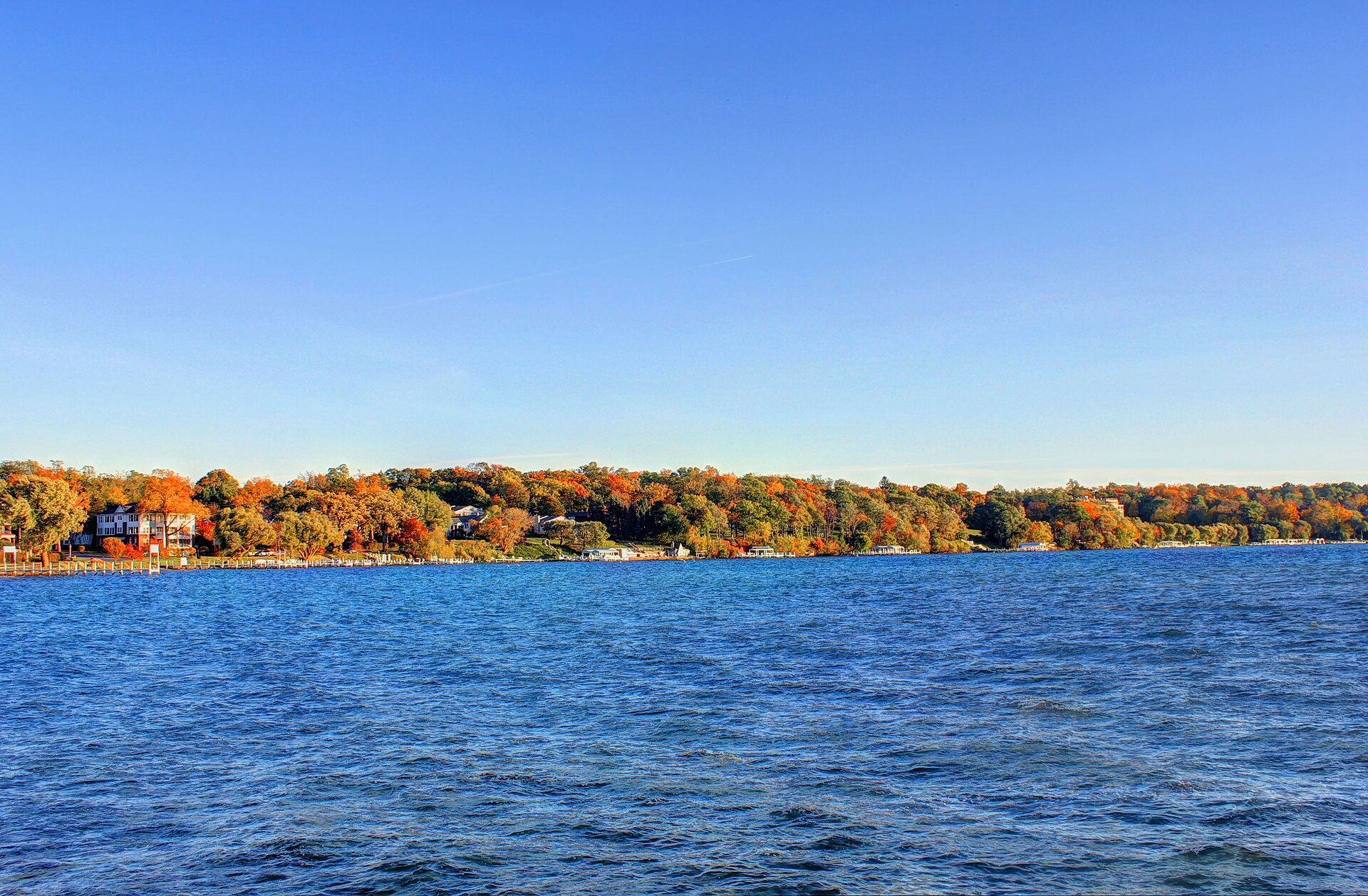 Fall foliage along the shoreline seen across Geneva Lake.