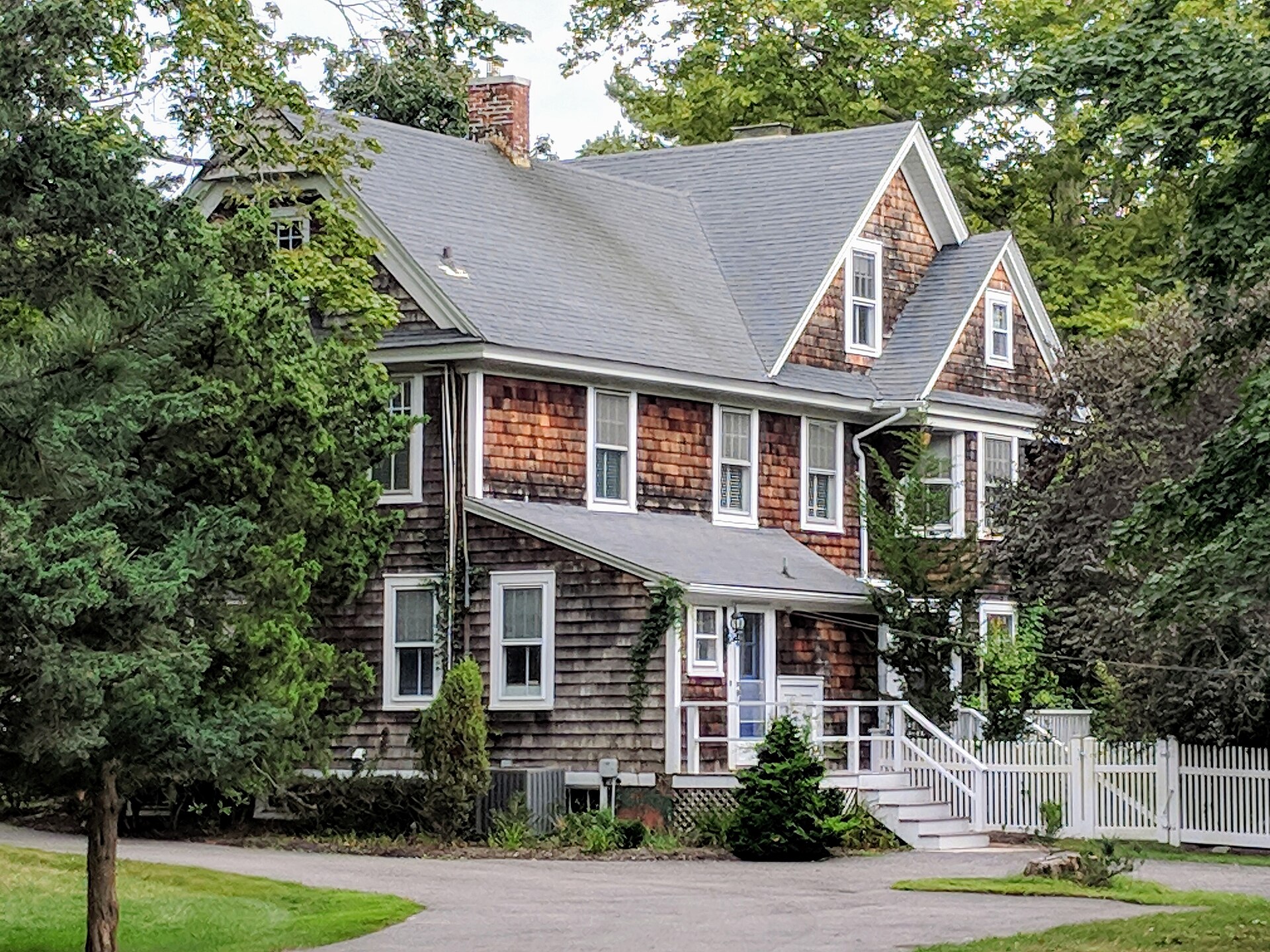 Classic shingle-style house with gambrel roof in Quiogue