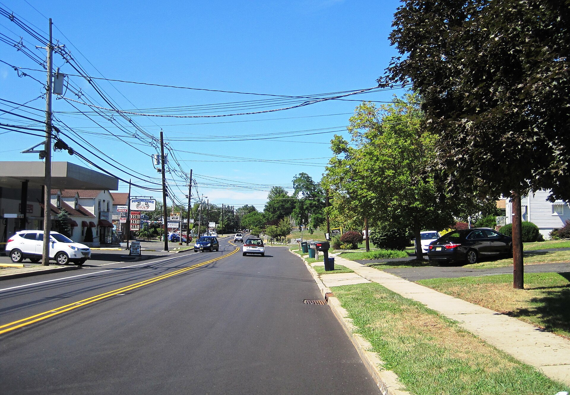 A main road through Bradley Gardens with shops and homes