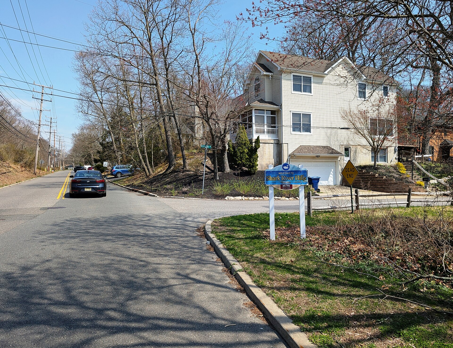 A 'Welcome to Shark River Hills' sign on Brighton Avenue in Neptune Township, New Jersey
