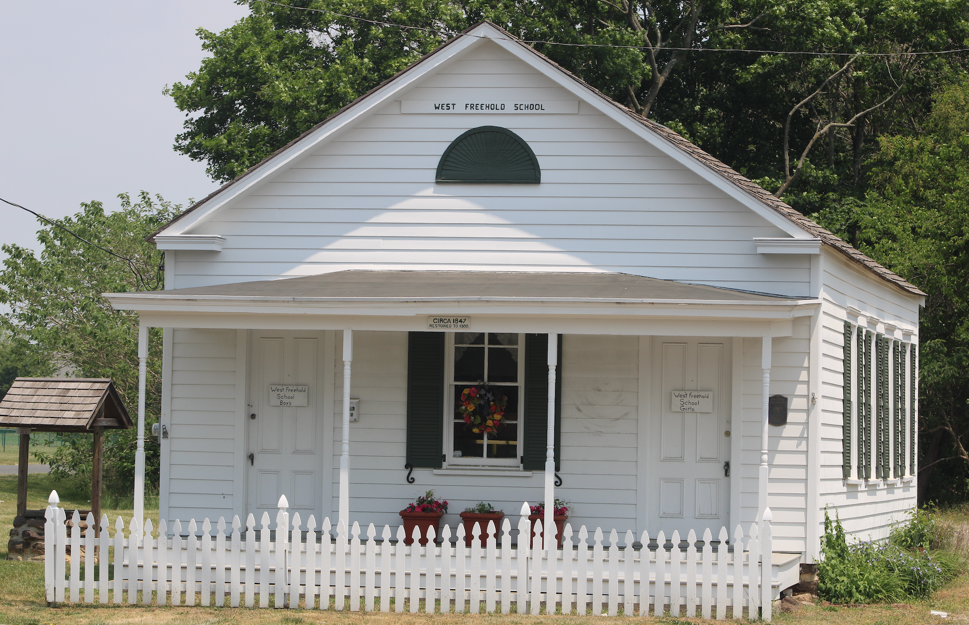 The small white historic schoolhouse in West Freehold, New Jersey.