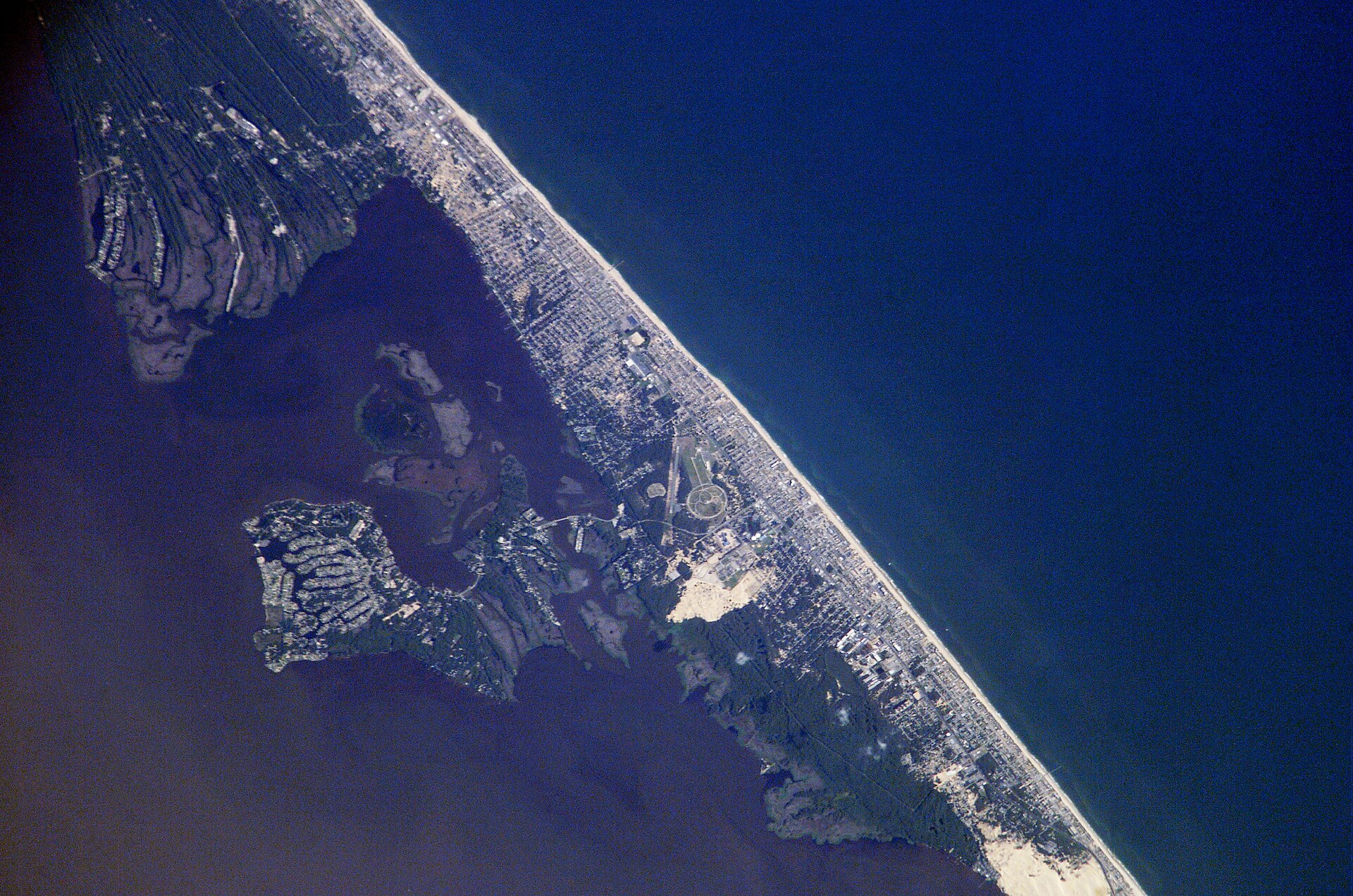 Aerial photograph of barrier islands, inlets, and the Atlantic coastline.