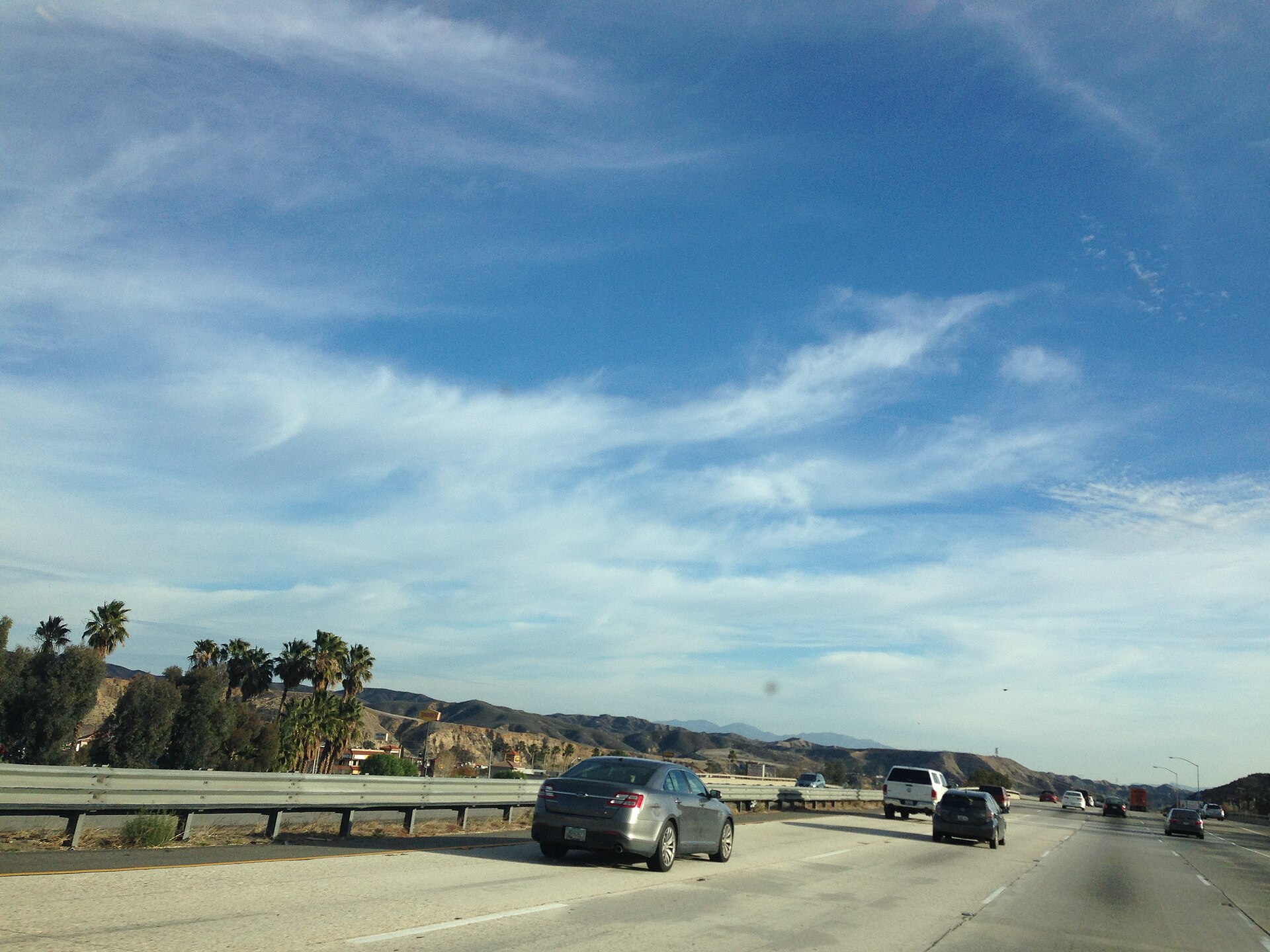 Highway through rolling hills near Castaic, by Hasley Canyon
