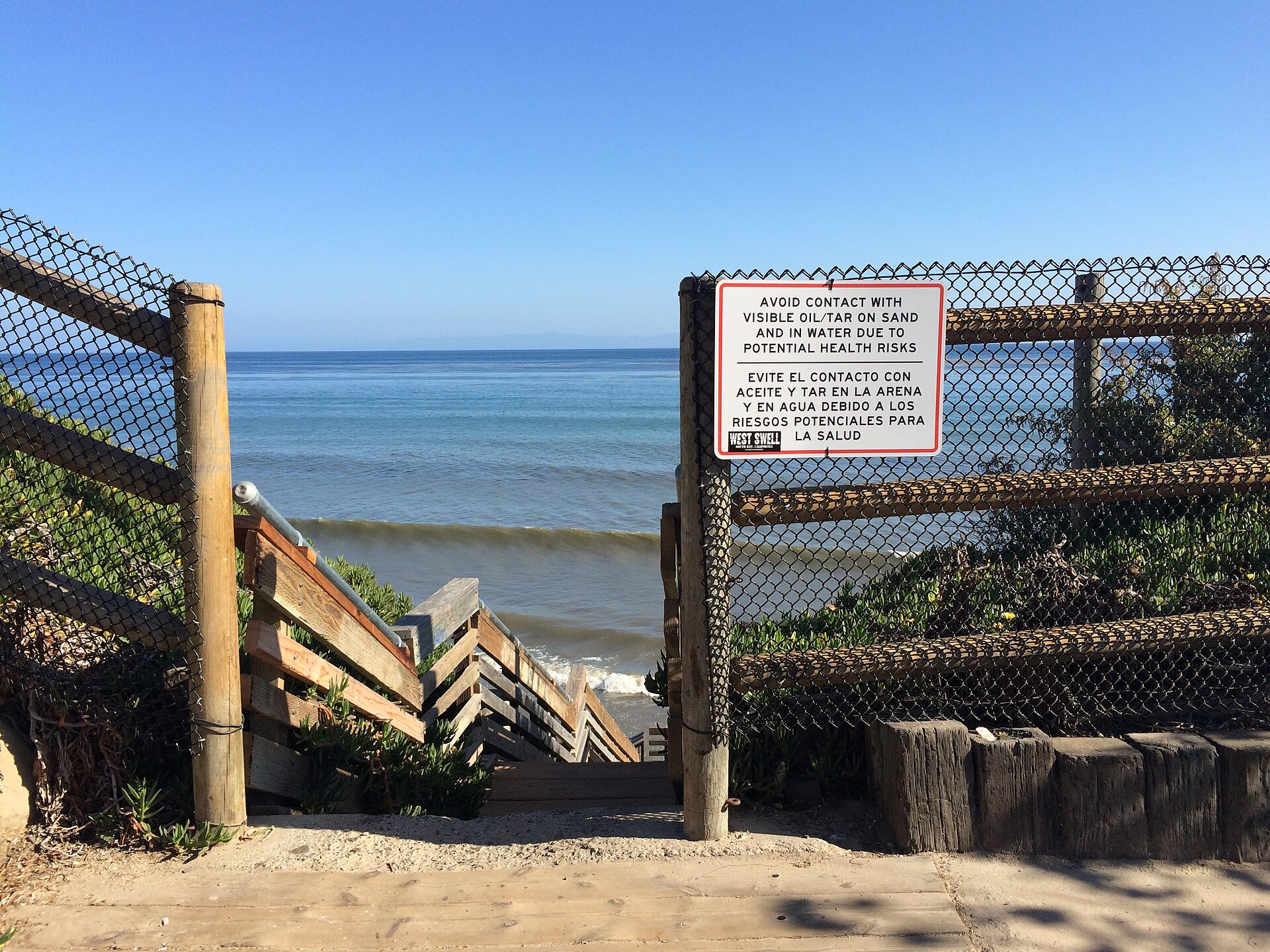 Oil industry warning sign on the bluffs in Isla Vista