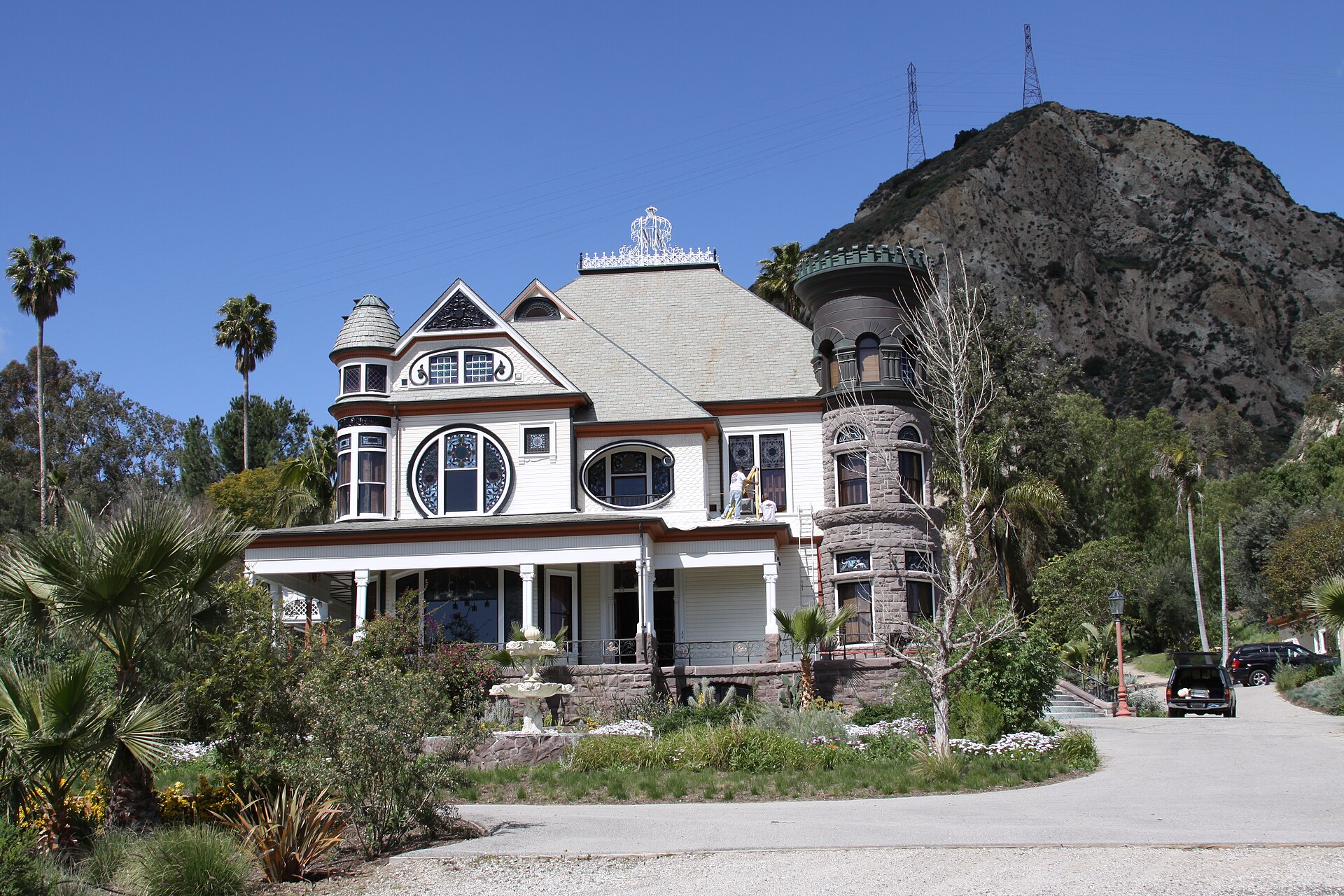 The Victorian Piru Mansion with its ornate gables and stone tower