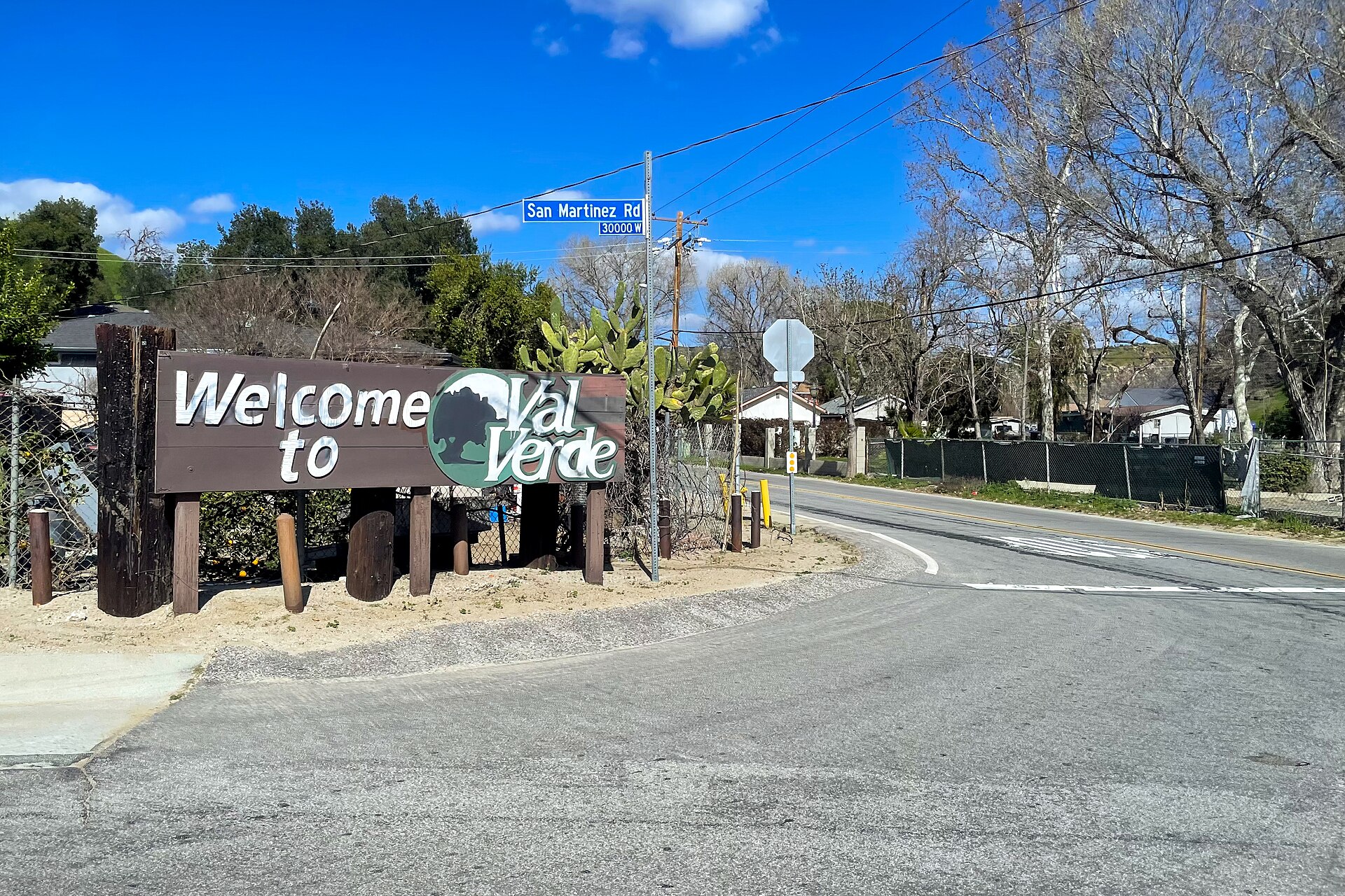 A brown highway sign welcoming visitors to Val Verde California.