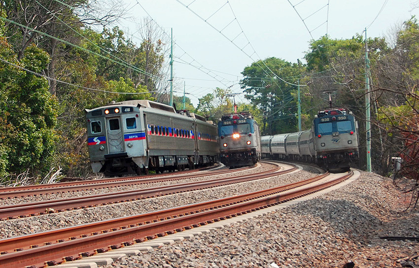 Passenger trains on the curved rail tracks at Rosemont