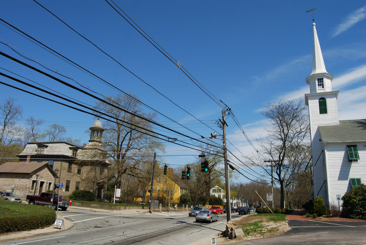 A street in Kingston Rhode Island with a white church and historic buildings.