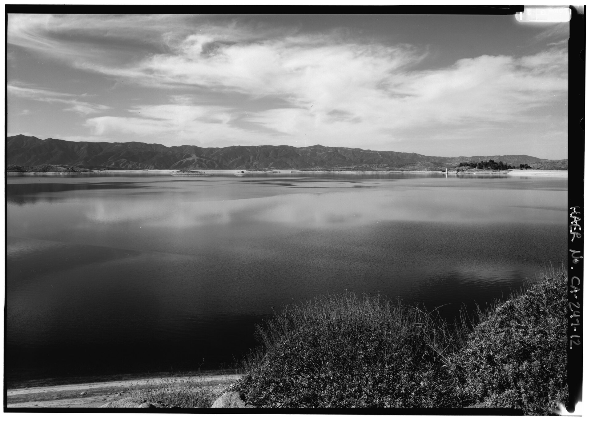 A ground-level view across Lake Mathews toward the outlet tower and dam.