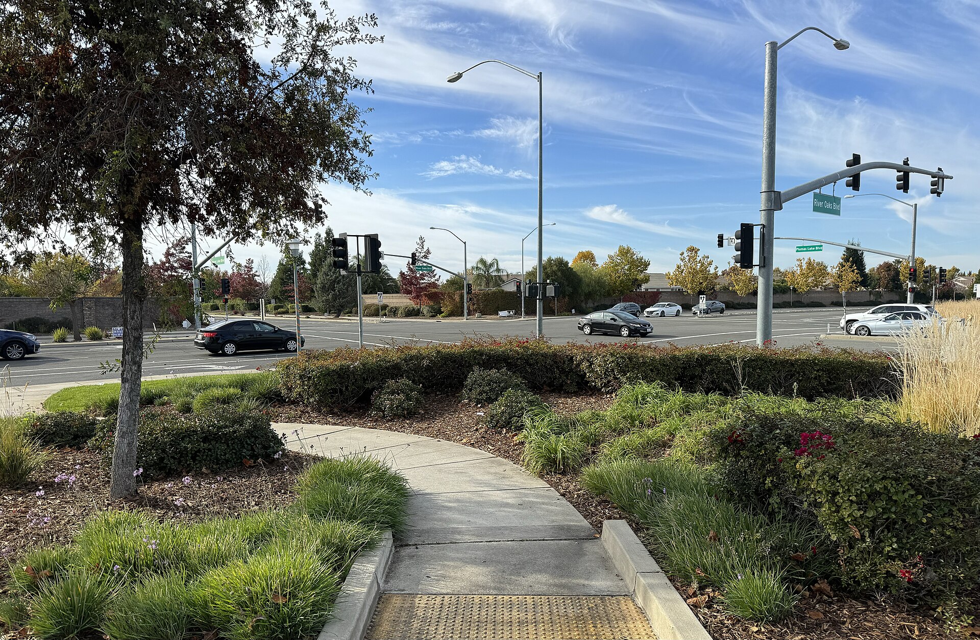A suburban intersection of Plumas Lake Boulevard and River Oaks Boulevard in Plumas Lake, California.