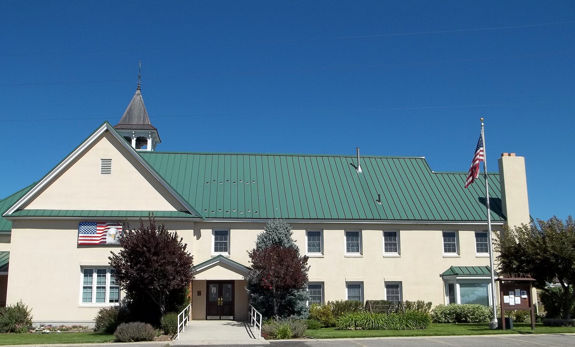 The Oakley, Utah town hall, a white building with a green roof.