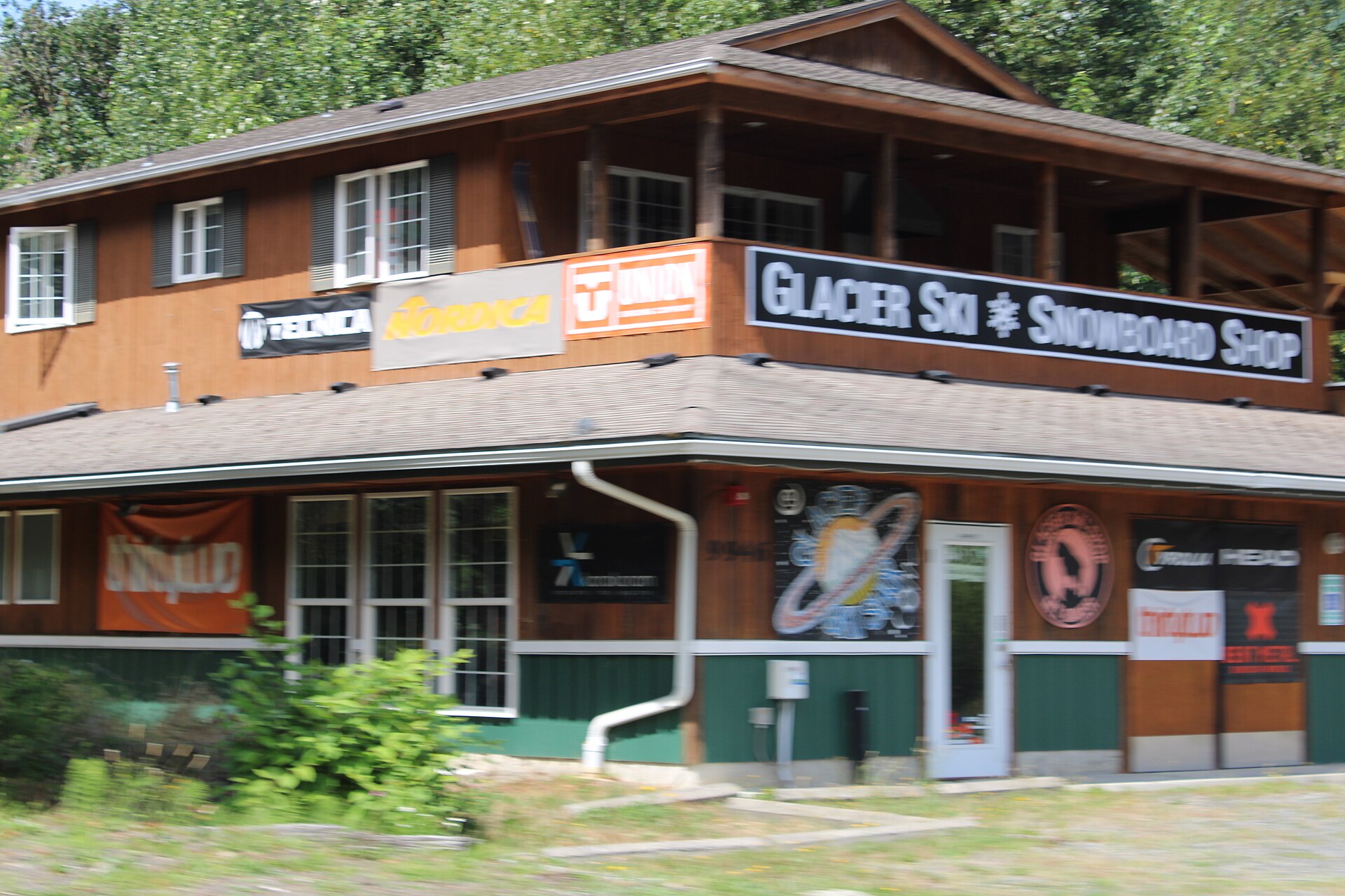 A wooden storefront with signs for Glacier Ski and Snowboard in Glacier, Washington.