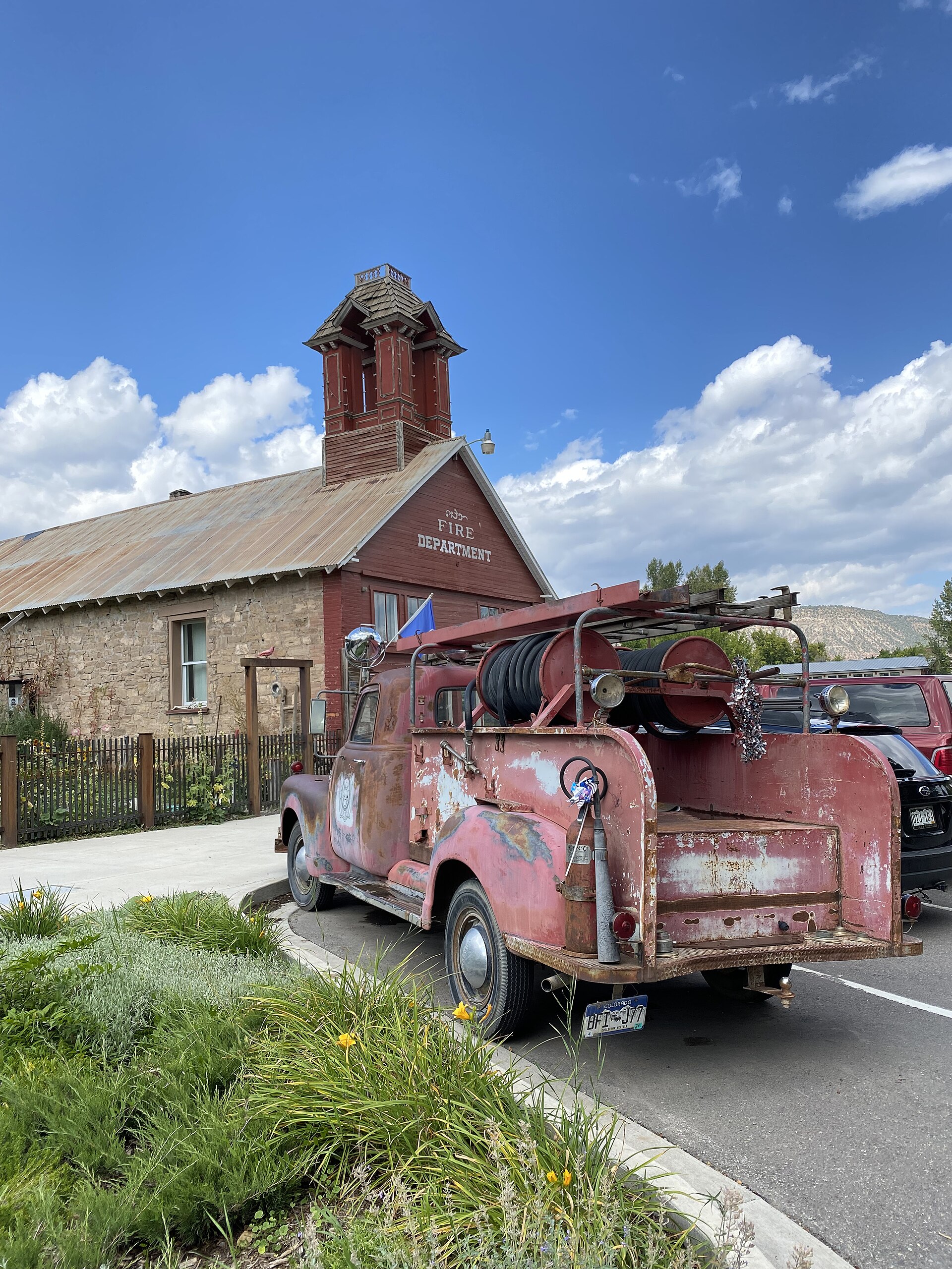 Historic 1882 firehouse with a vintage fire truck in Ridgway