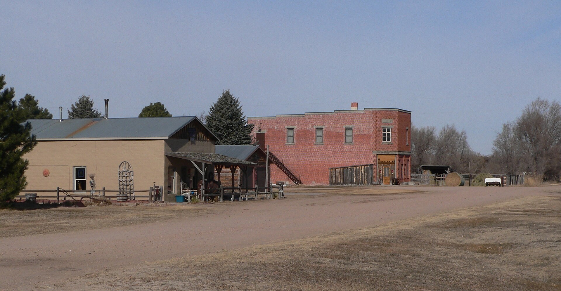 A wide view of downtown Gandy, Nebraska, with its brick IOOF hall and storefronts on Broadway Avenue