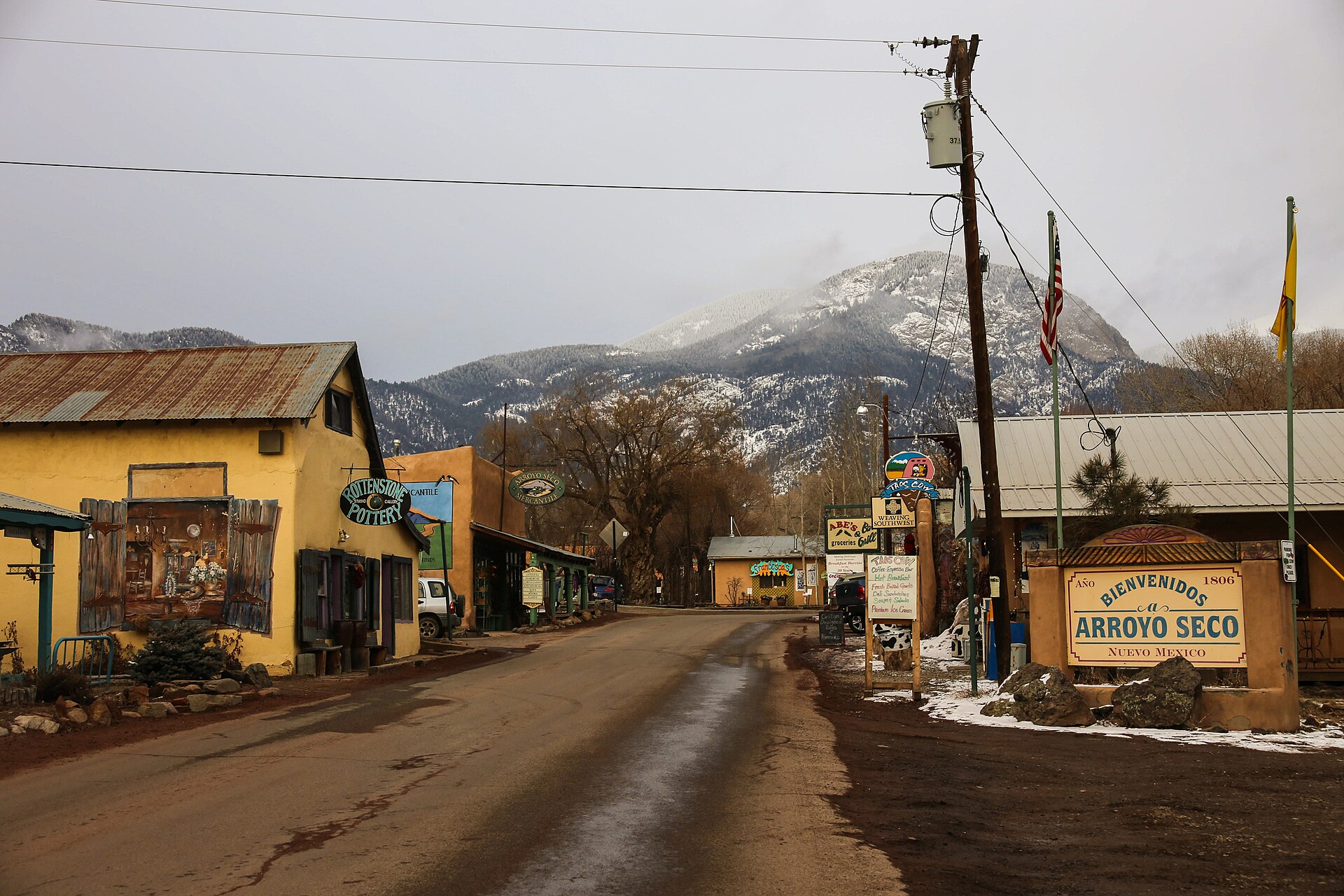 "Bienvenidos a Arroyo Seco" — main street in Arroyo Seco, New Mexico, with the mountains behind