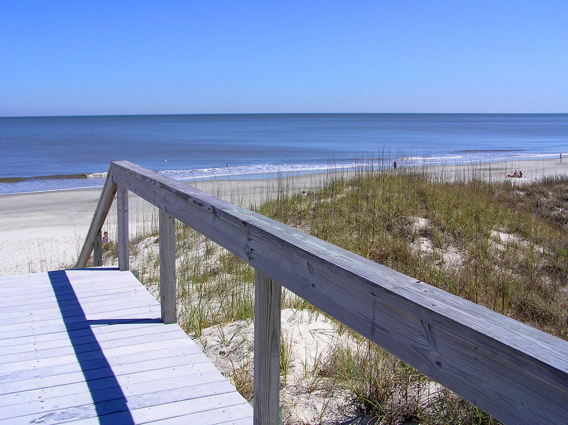 A wooden boardwalk leading over dunes to the beach on Jekyll Island Georgia.