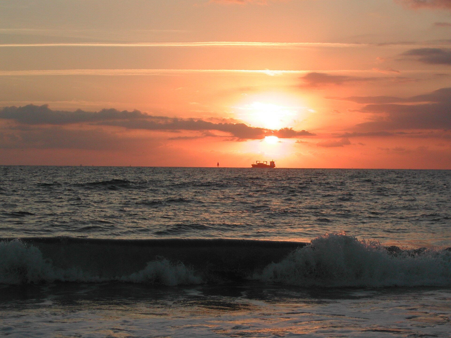 The sun rising over ocean waves at Tybee Island's north beach.