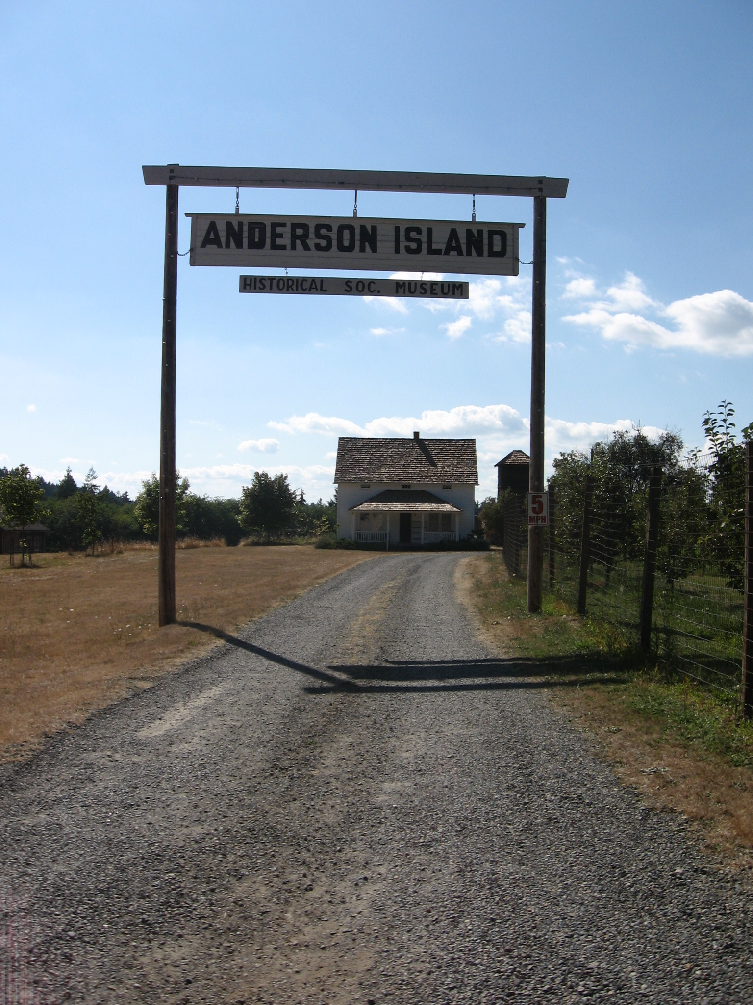 The Anderson Island Historical Society farm with its wooden sign and farmhouse in Washington