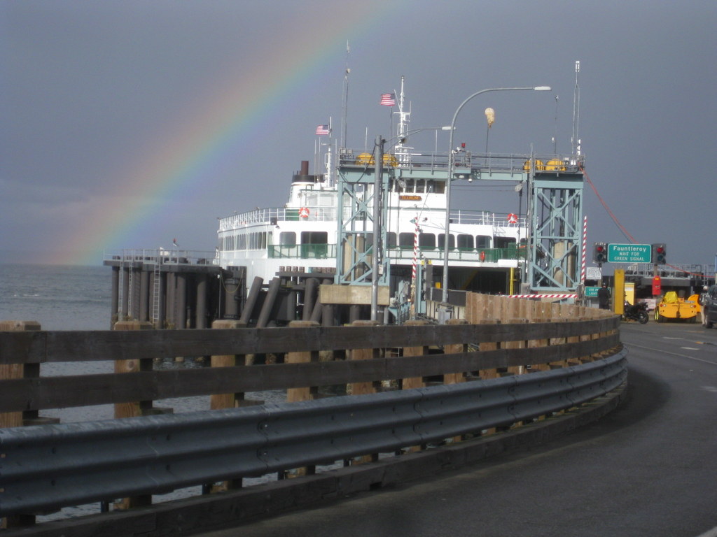 Ferry docked at the Southworth Ferry Terminal with a rainbow overhead