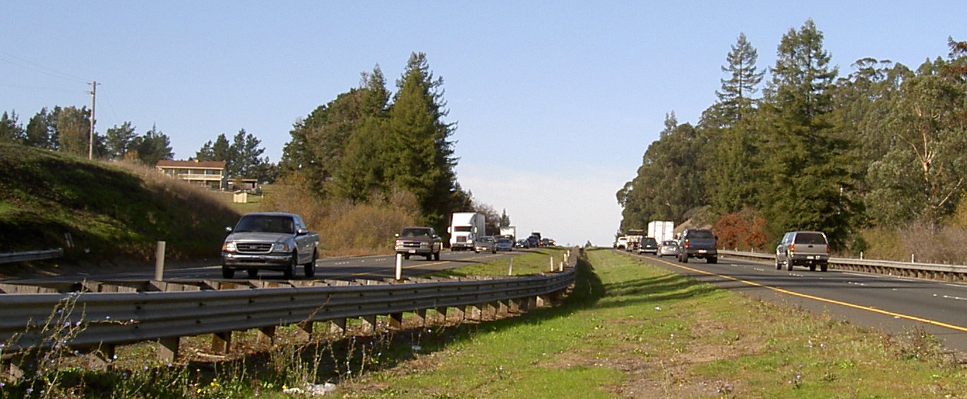 Highway 101 climbing the Cotati Grade with green hills on either side near Cotati, California.